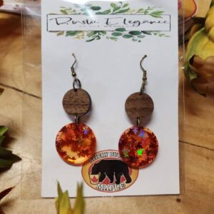 Fall Themed Circular Earrings Set on a Wooden Surface
